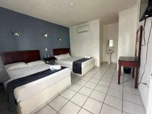 Postel nebo postele na pokoji v ubytování Hotel Grand Bahía Los Cocos