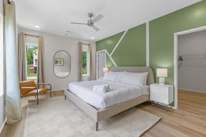 a bedroom with a large bed and a chair at Winton Flats by MilaPad in Atlanta