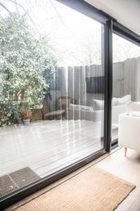 a living room with a large sliding glass door at Lowen Tree House in Truro