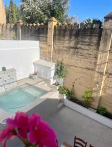 a backyard with a swimming pool and a fence at Casa Muralla del Alcazar Viejo in Córdoba