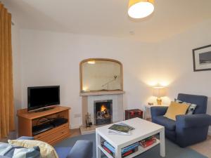 a living room with a fireplace and a mirror at Tigh a Phailean in Letterfearn