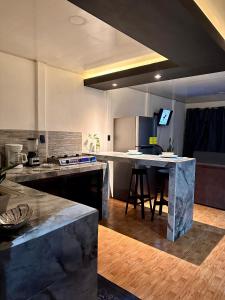 a kitchen with a counter and a table in it at Casa caribes in Puerto Limón