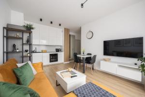 a living room with a couch and a table at WARSZAWSKI SEN. Apartament na 5 in Warsaw