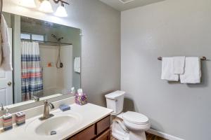 a bathroom with a sink and a toilet and a mirror at Fire Pit and Covered Patio Bullhead City Escape! in Bullhead City +16 photos