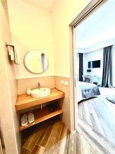 a bathroom with a sink and a mirror and a bed at All Comfort Astoria Palace in Rome