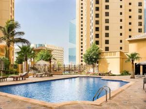 a large swimming pool in a city with buildings at Modern Oasis in Heart of Marina with Marina View - 11AB05 in Dubai