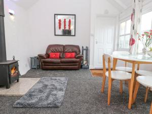 a living room with a couch and a table at Toadstools in Penryn