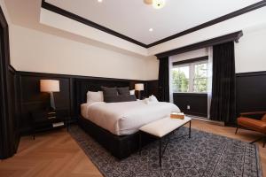 a bedroom with a large bed and a window at The Dorchester Hotel in Collingwood
