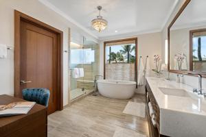 a large bathroom with a tub and a sink at Timbers Kauai Ocean Club & Residences in Lihue