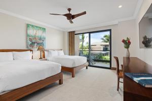 a hotel room with two beds and a window at Timbers Kauai Ocean Club & Residences in Lihue
