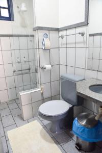 a bathroom with a blue toilet and a sink at Pousada Suiça in Santa Leopoldina