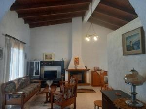 a living room with a couch and a fireplace at Sunhouse Vrachati in Vrahati