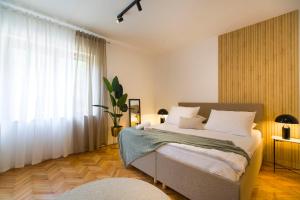 a bedroom with a bed and a large window at Apartments Marija in Brna