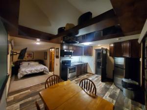 um pequeno quarto com uma cama e uma mesa de madeira em The Garden House em Rapid City