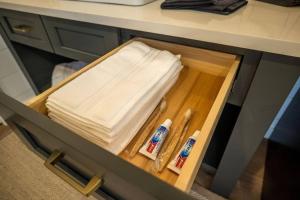 a drawer in a desk with towels and utensils at Forest Hideaway in Guntersville