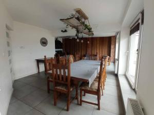 a dining room with a table and wooden chairs at Stodoła z widokiem in Żywiec