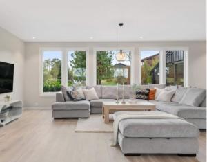 a living room with a couch and a table at Tranquil Haven Villa in Ålesund