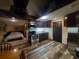 a room with a kitchen with a bed and a stove at The Garden House in Rapid City