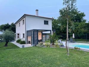 a white house with a pool in the yard at Villa Jasmin in Gradignan