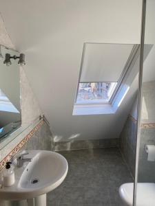 a bathroom with a sink and a window at LAS ALBRICIAS in León