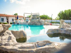 a swimming pool with a water slide in a resort at Residence Arco delle Rose in Agropoli