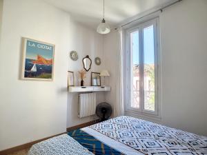 a bedroom with a bed and a window at CASA BLUE sur une jolie place proche du vieux port by LaConciergerie13 in La Ciotat