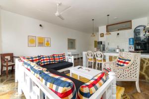 a living room with a couch and a table at Mayweather One Bedroom Apartment, with Beach Access, Malindi in Malindi