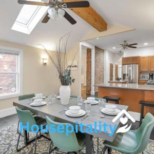 a dining room table with chairs and a ceiling fan at OSU and Short North 4 Bedroom Patio and Garage with EV in Columbus
