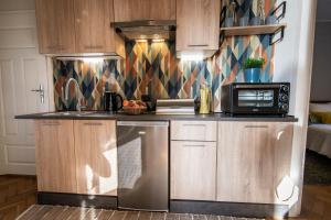 a kitchen with a refrigerator and a microwave at Nadmorski Apartament w Orłowie in Gdynia +9 photos