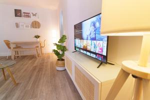 a living room with a flat screen tv on a wall at Casa Arai en Casco Histórico con Parking Gratuito in Ronda