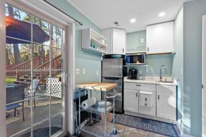 a kitchen with white cabinets and a table and a balcony at West Fairway in Coeur d'Alene