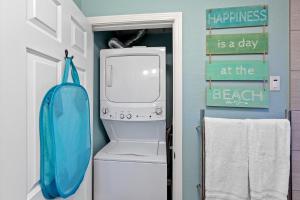 a bathroom with a washer and dryer in it at Osprey on Fairway Coeur d' Alene ID in Coeur d'Alene +2 photos