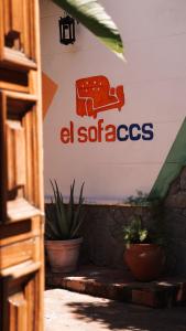 a sign that says al spicesacs on a wall with plants at El Sofá Caracas in Caracas
