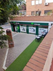 a building with a green lawn in front of it at Tu casita en El Zapillo in Almería