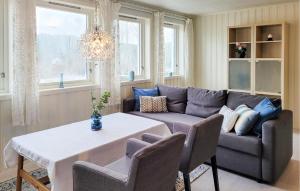 a living room with a couch and a table at Cozy Apartment In Sveio With Kitchen in Sveio