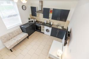 an overhead view of a kitchen with a couch and a microwave at 33 Stanley Road in Northampton