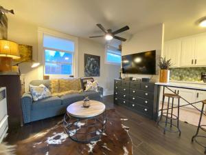 a living room with a couch and a table at The Chic Guest Retreat in Old Town near CSU! in Fort Collins