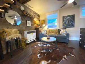 a living room with a couch and a table at The Chic Guest Retreat in Old Town near CSU! in Fort Collins