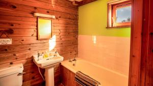 a bathroom with a sink and a tub and a toilet at The New Farmhouse in Biggar +28 photos