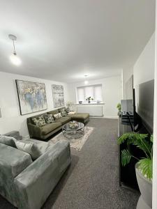 a living room with a couch and a table at Beautiful home in Ince-in-Makerfield