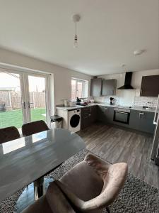 a kitchen with a table and chairs in a room at Beautiful home in Ince-in-Makerfield