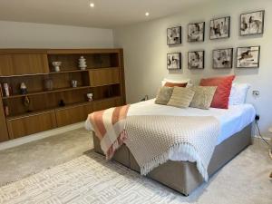 a bedroom with a bed with pillows on it at Beachcliff Rooms & Apartments in Cardiff