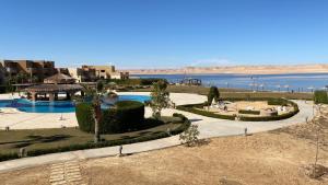 arial view of a resort with a body of water at Byoum lake side hotel room, Tunis village, fayoum in Qaryat at Ta‘mīr as Siyāḩīyah