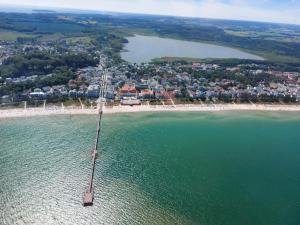 an aerial view of a beach with a pier in the water at Residenz Dünenstrasse in Binz