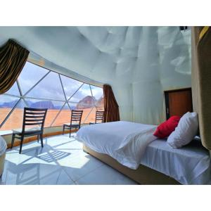 a woman sitting on a bed in a yacht at European luxury camp in Disah