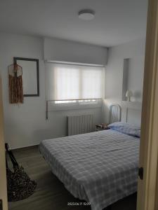 En eller flere senge i et værelse på Apartamento Shoping Center