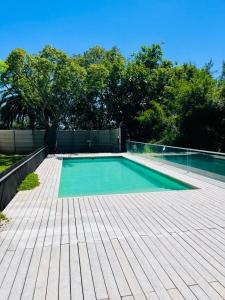 a swimming pool on top of a wooden deck at Frente al Rio in Zárate