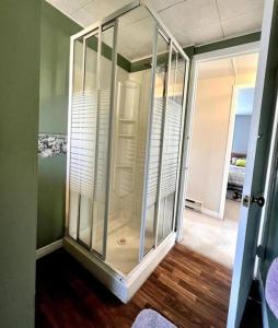 a glass closet in a room with wooden floors at Rosedale Cottage@Baksam lake in Fenelon Falls