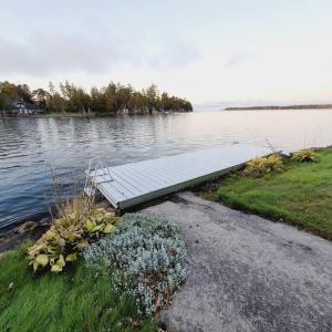 a dock in the middle of a body of water at Rosedale Cottage@Baksam lake in Fenelon Falls