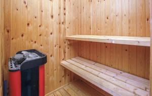 a wooden sauna with a trash can in it at Holiday Home Hvedemarken Sjølund Xii in Hejls